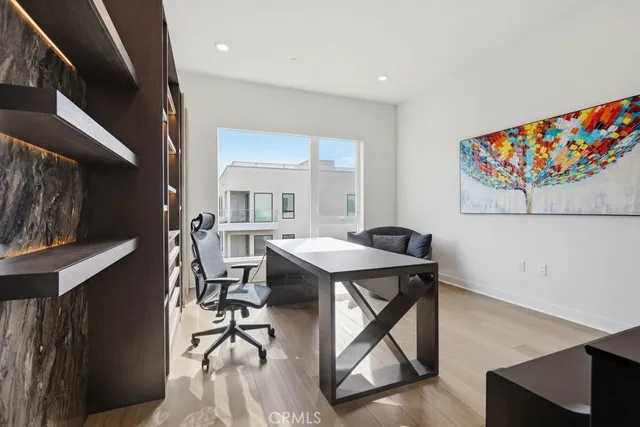 a large white building with glass top table and chairs