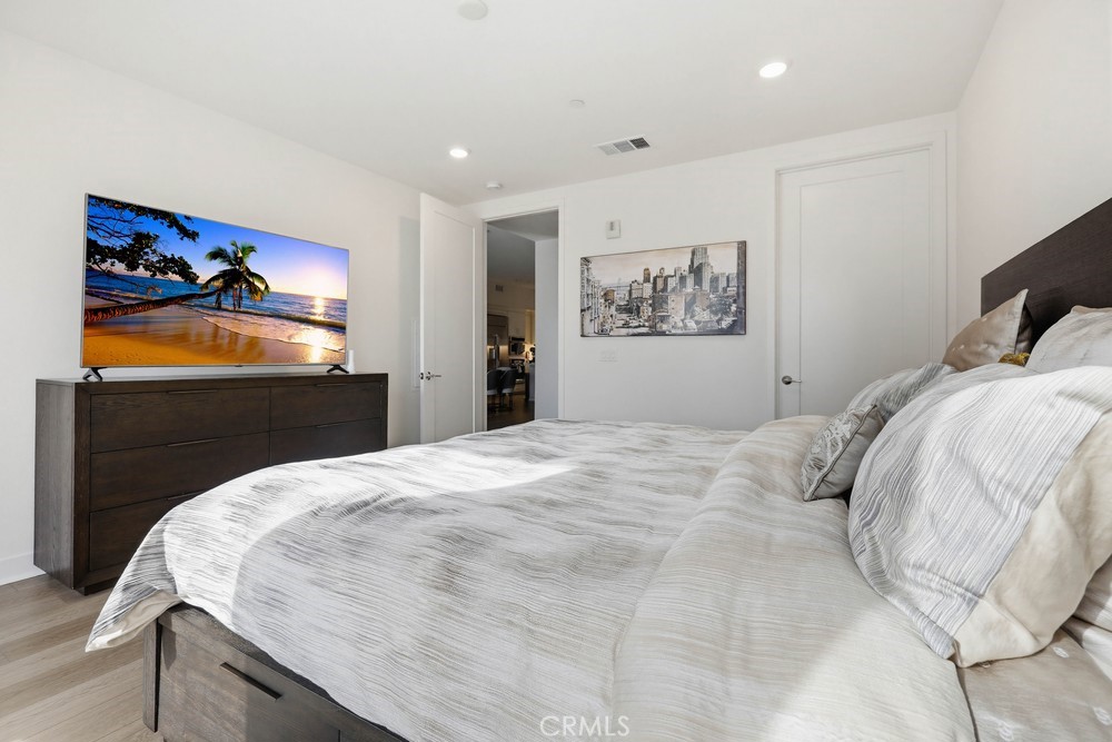 1604 Rivington Irvine, CA 92612 - Photo 58 of 75 a bedroom with a bed and a painting on the wall