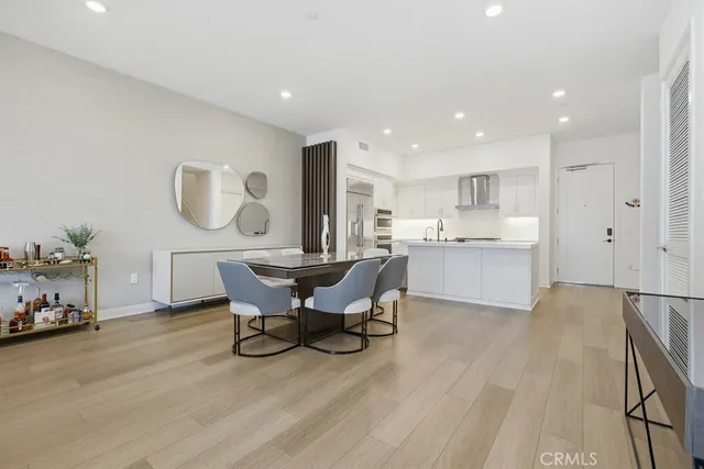 a view of a dining room with furniture a rug and wooden floor