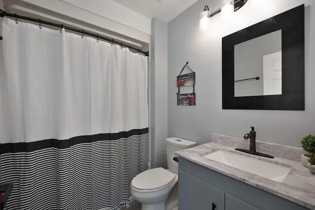 an empty room with a window and a ceiling fan