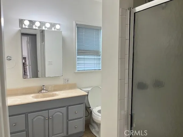 a bathroom with a sink tub shower and a mirror