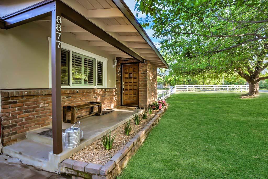 a view of a house with backyard porch and sitting area