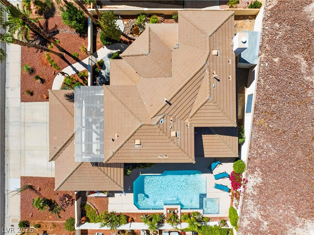 1135 Calico Ridge Drive Henderson, NV 89011 - Photo 61 of 86 An aerial perspective reveals a private pool with ample patio space, nestled within a neatly landscaped yard.
