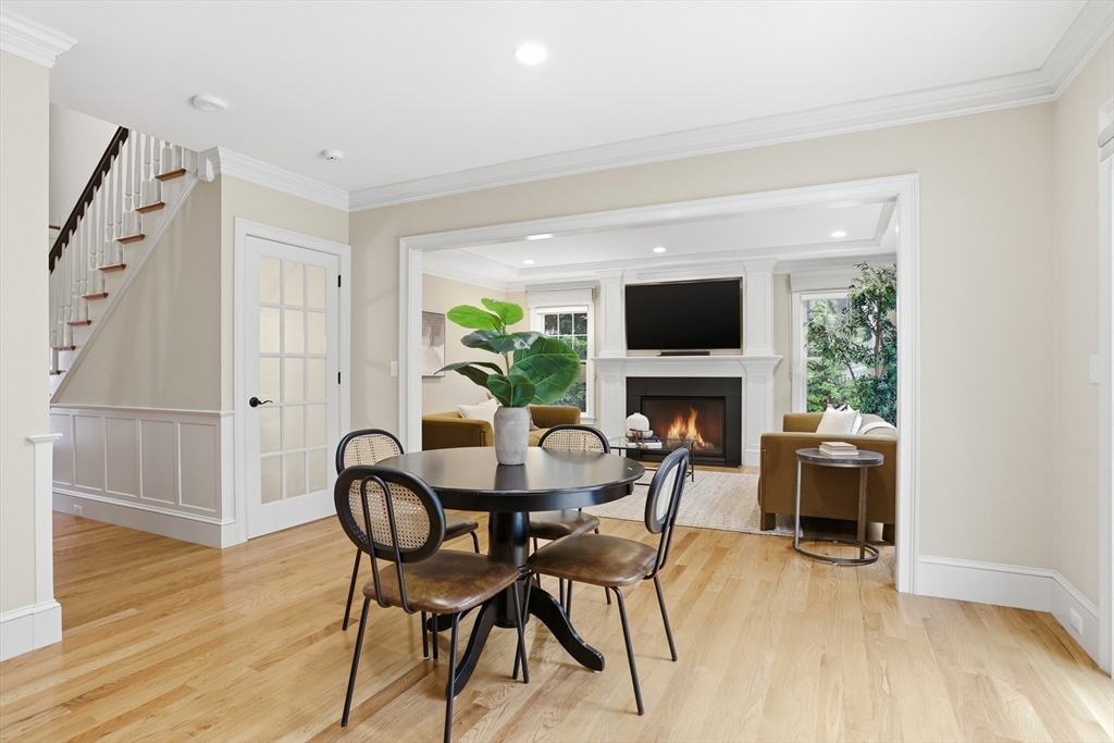 27 Maxwell Road Bedford, MA 01730 - Photo 11 of 42 a view of a dining room with furniture and a fireplace