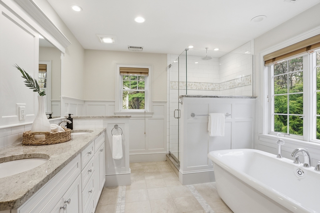 27 Maxwell Road Bedford, MA 01730 - Photo 24 of 42 a bathroom with a granite countertop sink and a bathtub