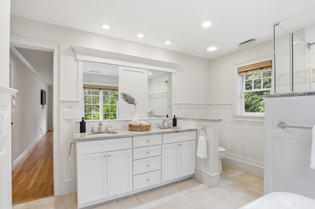 27 Maxwell Road Bedford, MA 01730 - Photo 25 of 42 a bathroom with a double vanity sink a toilet and a window