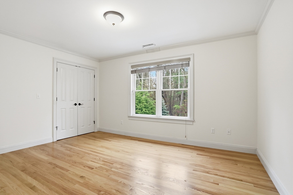 27 Maxwell Road Bedford, MA 01730 - Photo 28 of 42 an empty room with wooden floor and windows