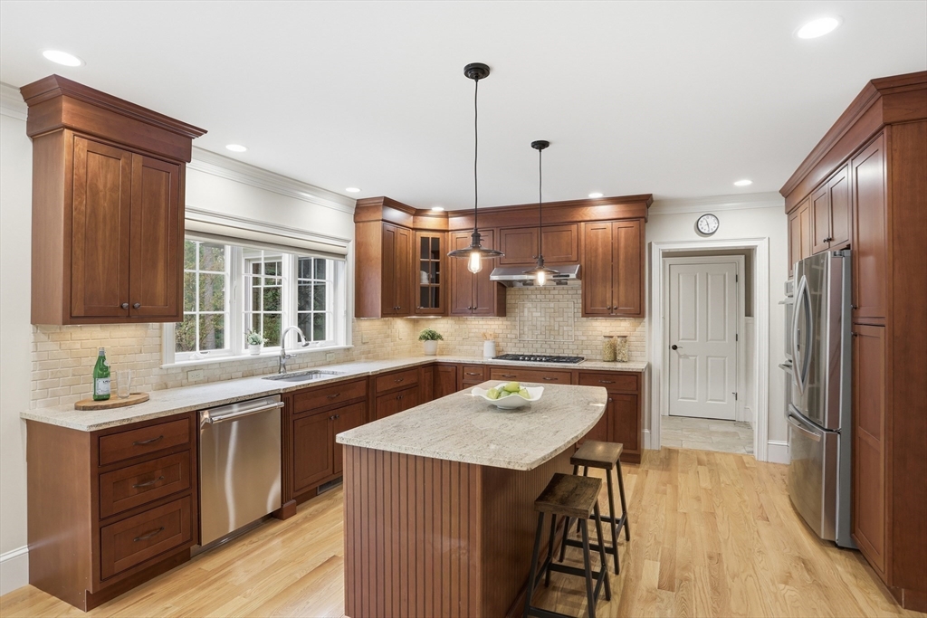 27 Maxwell Road Bedford, MA 01730 - Photo 3 of 42 a kitchen with stainless steel appliances granite countertop a sink stove and refrigerator