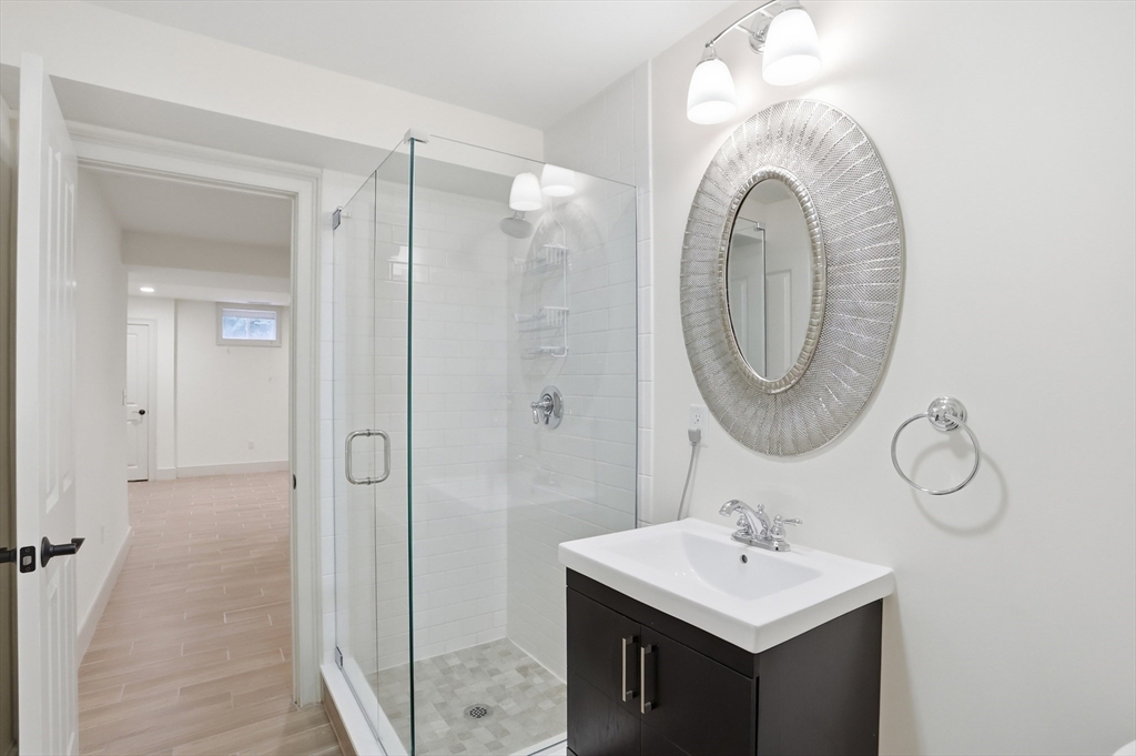 27 Maxwell Road Bedford, MA 01730 - Photo 33 of 42 a bathroom with a sink a mirror and a shower