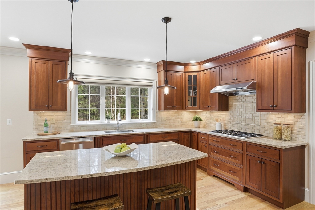 27 Maxwell Road Bedford, MA 01730 - Photo 6 of 42 a kitchen with stainless steel appliances granite countertop wooden cabinets a sink and a window