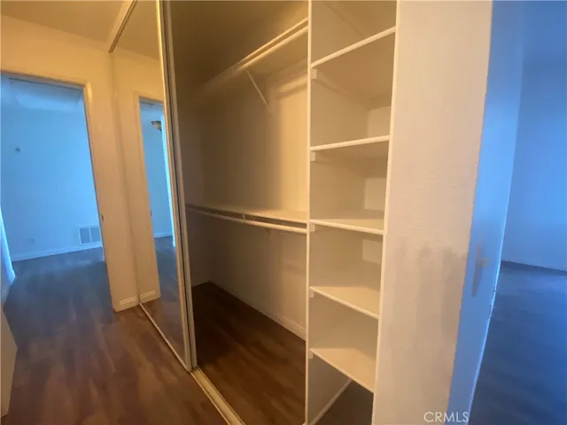 a view of walk in closet with empty racks