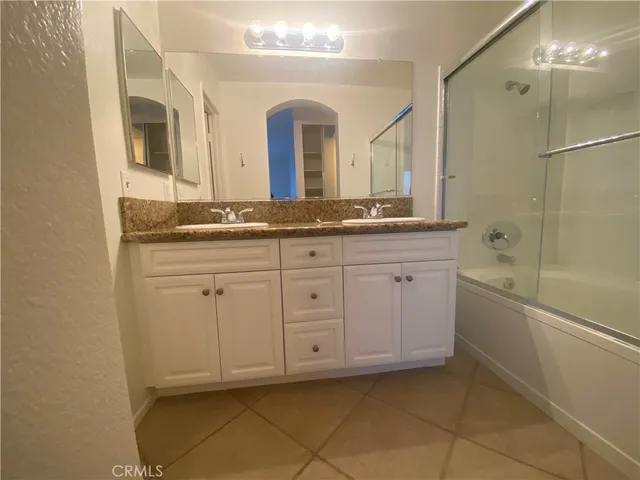 a bathroom with a granite countertop sink a mirror and a