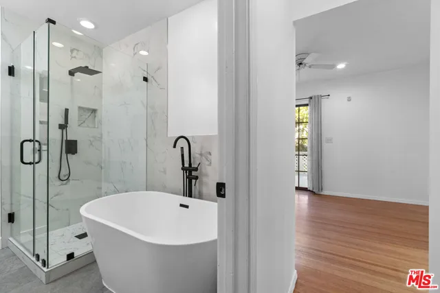 a white bath tub sitting next to a bathroom