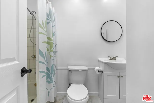 a white toilet sitting next to a bathroom sink