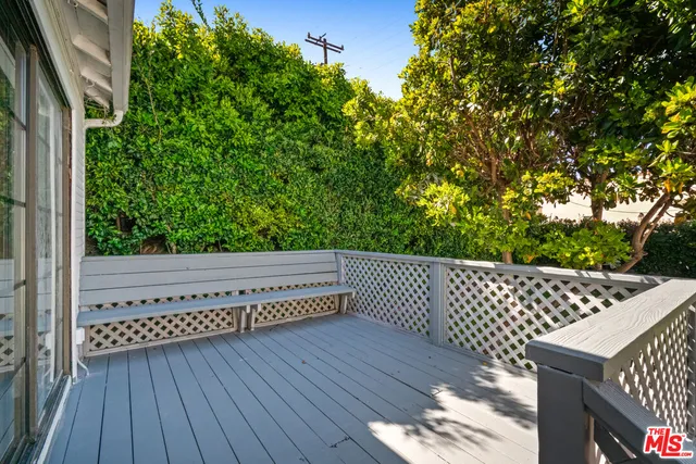 a view of balcony with wooden floor