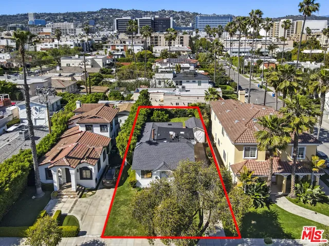 an aerial view of a houses with a city view