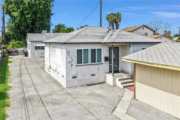 a view of a house with a wooden fence