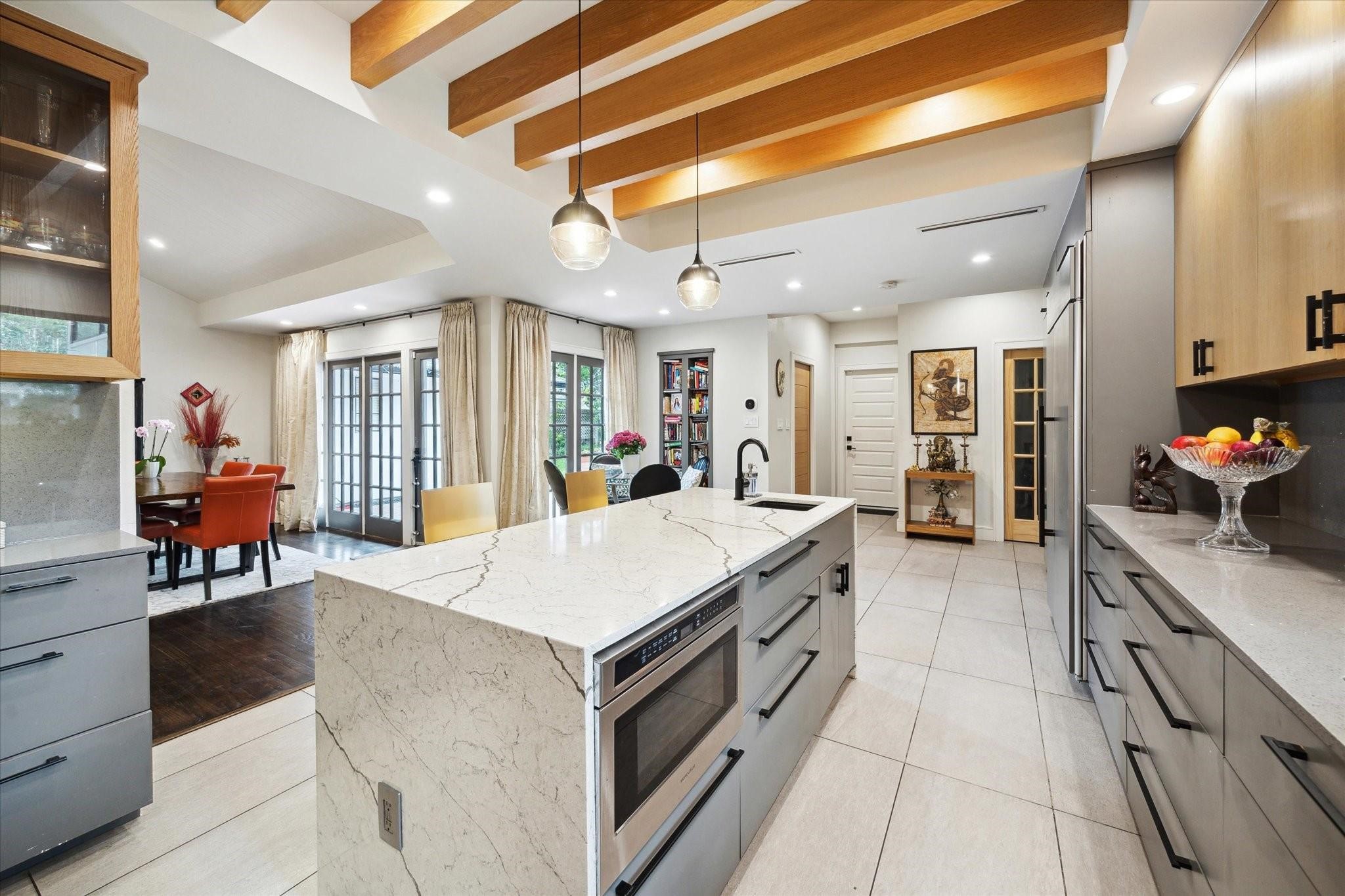 1902 Chimney Rock Road Houston, TX 77057 - Photo 12 of 32 Another lovely view of the kitchen, with dining area to the left and the pantry/wine closet to the right near the refrigerator/freezer. The island holds the microwave and soft close drawers.