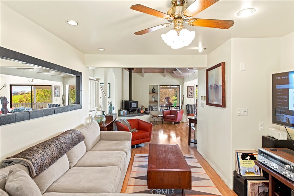 8255 Balboa Road Atascadero, CA 93422 - Photo 25 of 72 a living room with furniture a fireplace and a flat screen tv
