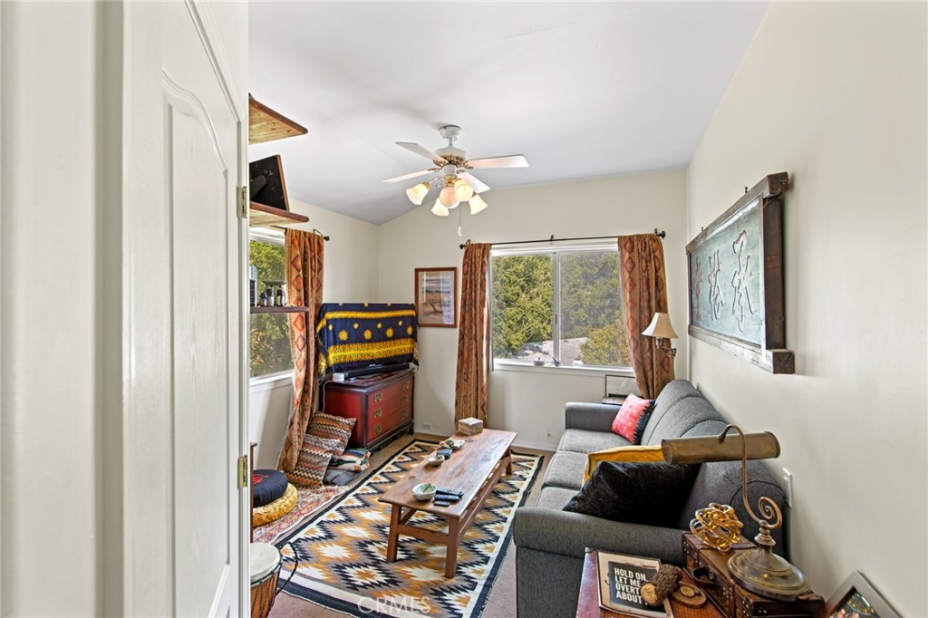 8255 Balboa Road Atascadero, CA 93422 - Photo 37 of 72 a living room with furniture a fireplace and a chandelier