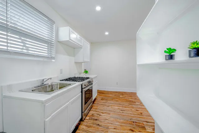 a kitchen that has a sink and a stove