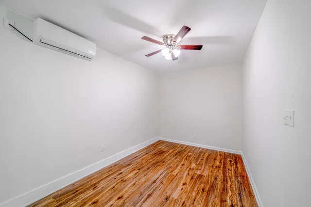 a view of a room with wooden floor