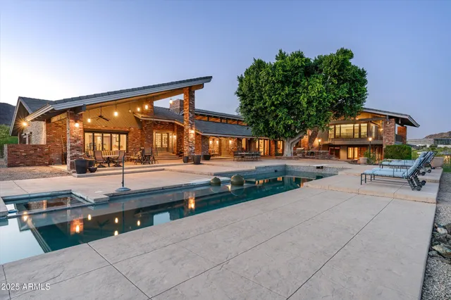 a view of a patio with table and chairs and floor to ceiling window