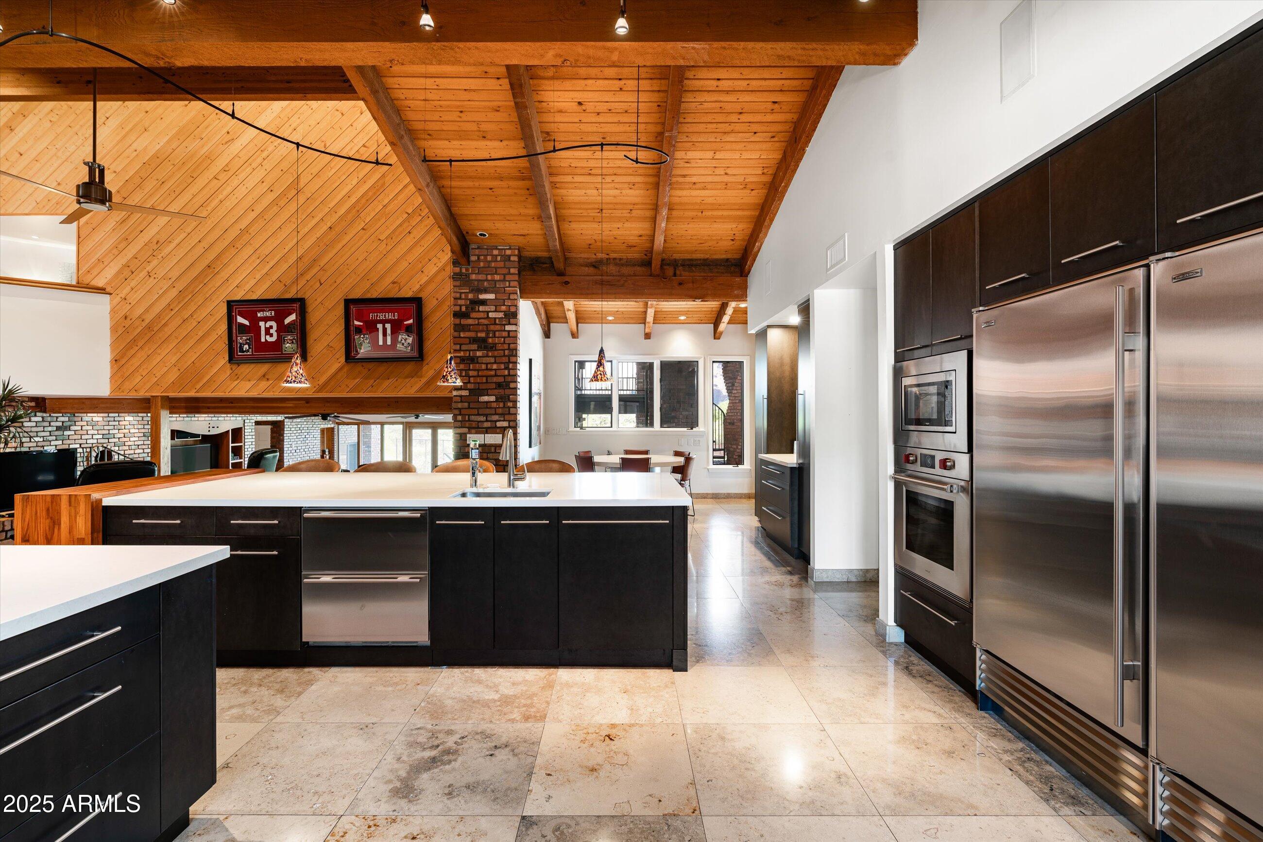 6830 North 46th Place Paradise Valley, AZ 85253 - Photo 13 of 65 a kitchen with stainless steel appliances granite countertop a sink and a counter