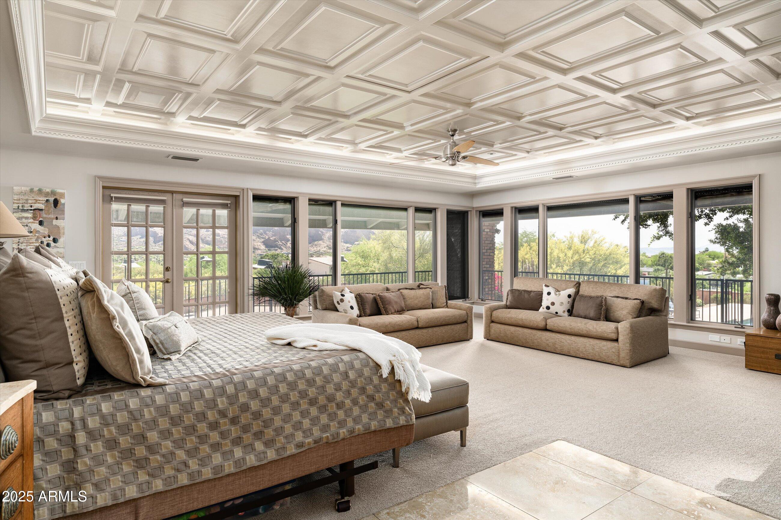 6830 North 46th Place Paradise Valley, AZ 85253 - Photo 22 of 65 a bedroom with a bed couch and large window with outer view