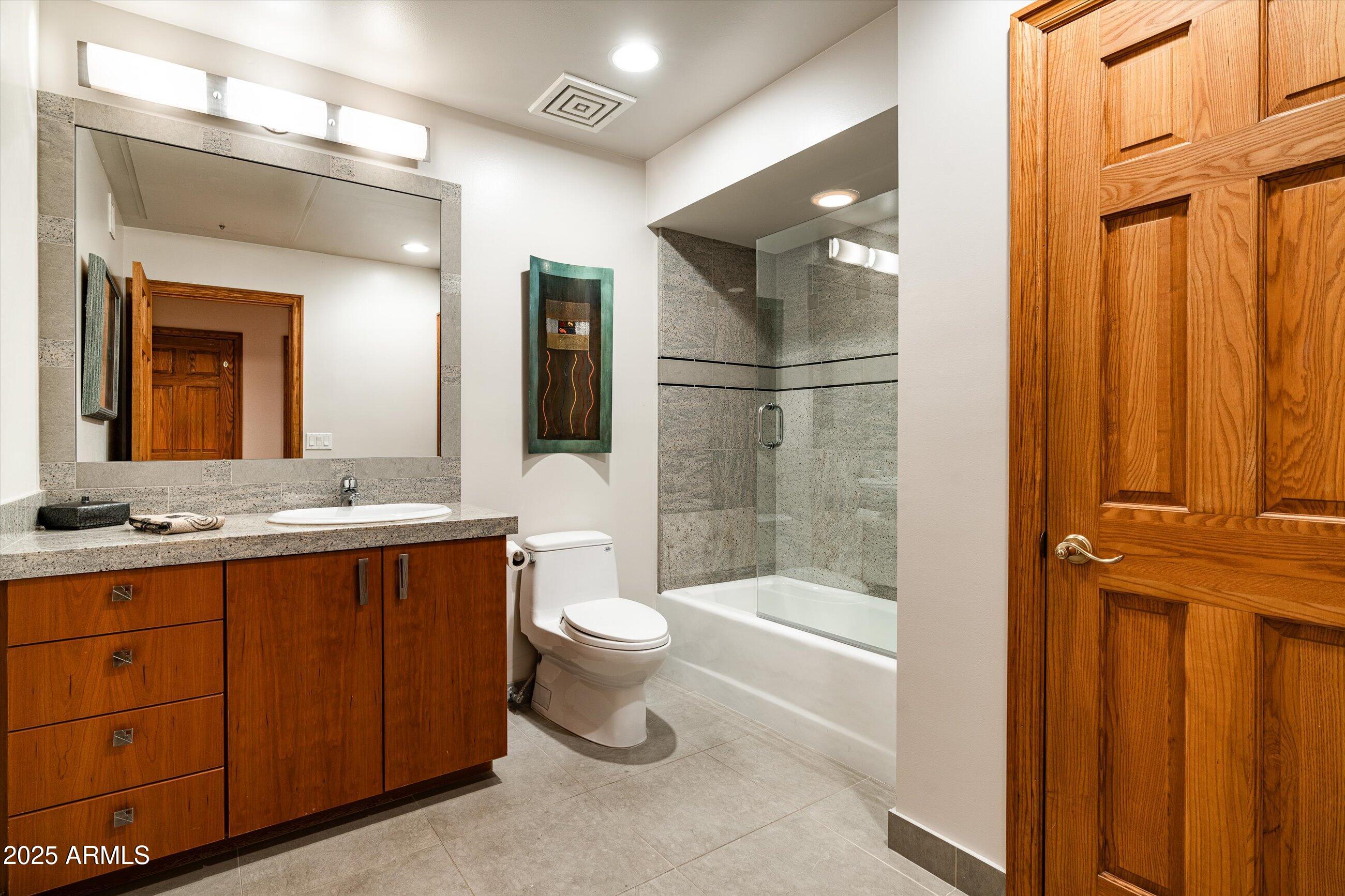 6830 North 46th Place Paradise Valley, AZ 85253 - Photo 27 of 65 a bathroom with a bathtub shower sink mirror and toilet