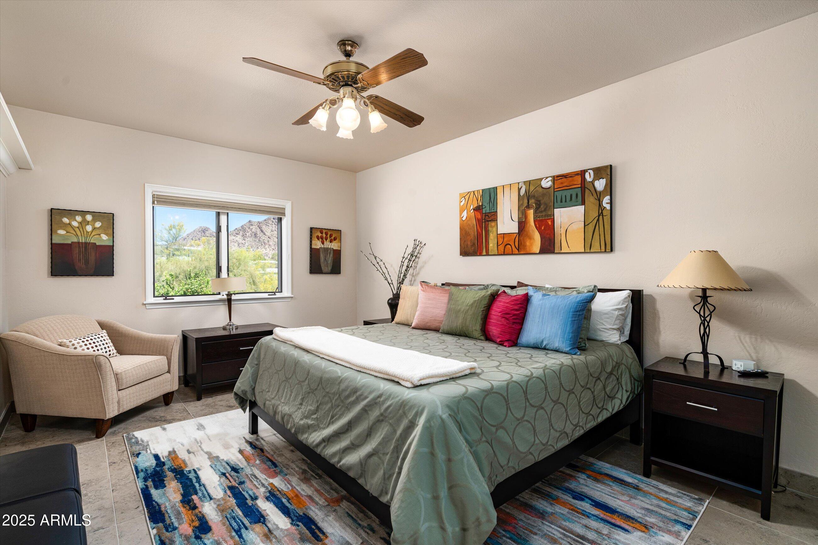 6830 North 46th Place Paradise Valley, AZ 85253 - Photo 30 of 65 a bedroom with a bed and wooden floor