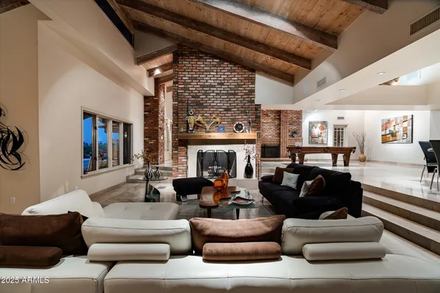 a view of swimming pool with outdoor seating and plants