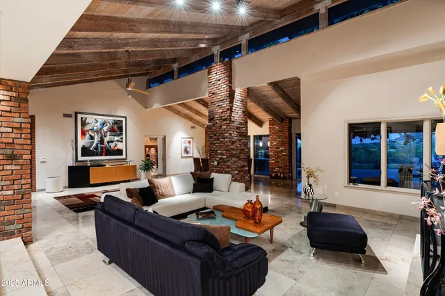 a living room filled with furniture window and a table and chairs