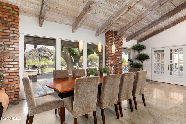 a swimming pool view with a seating space and a garden view