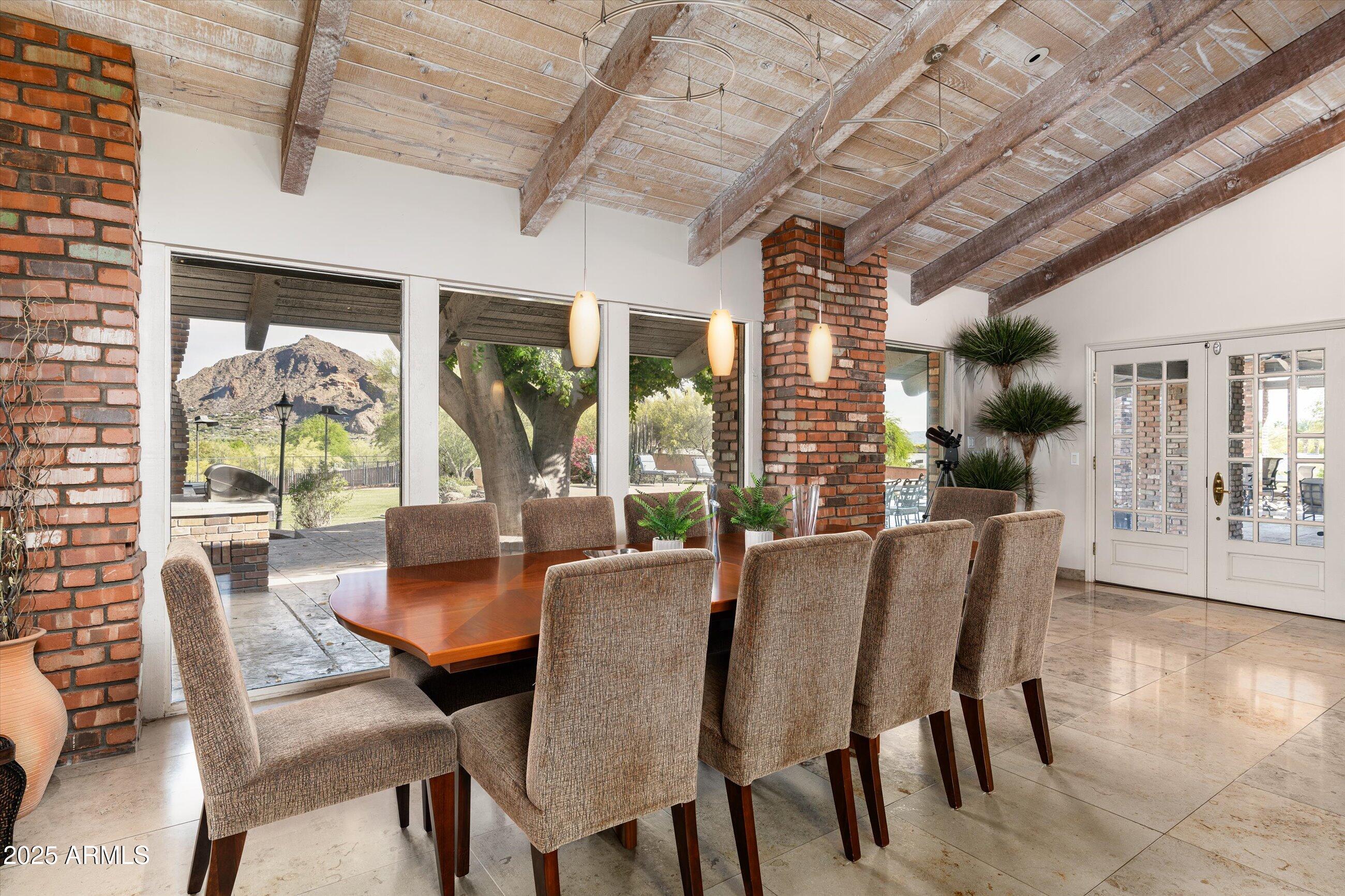 6830 North 46th Place Paradise Valley, AZ 85253 - Photo 41 of 65 a view of a dining room with furniture large windows and wooden floor