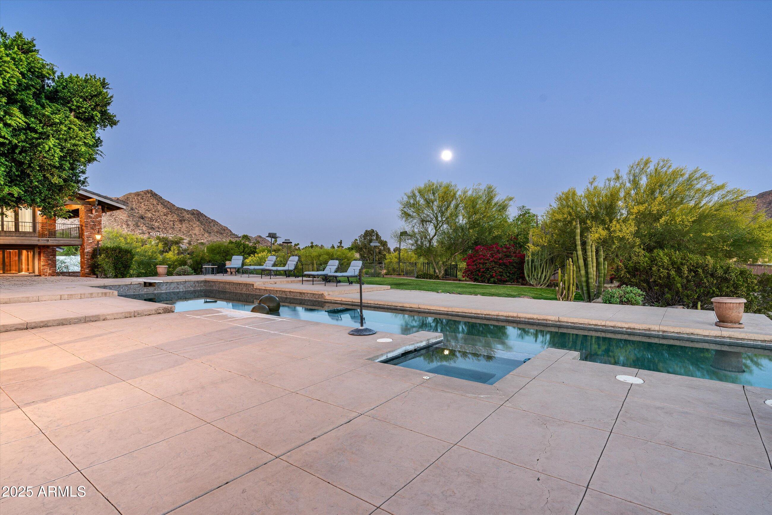6830 North 46th Place Paradise Valley, AZ 85253 - Photo 47 of 65 a view of swimming pool with outdoor seating and plants