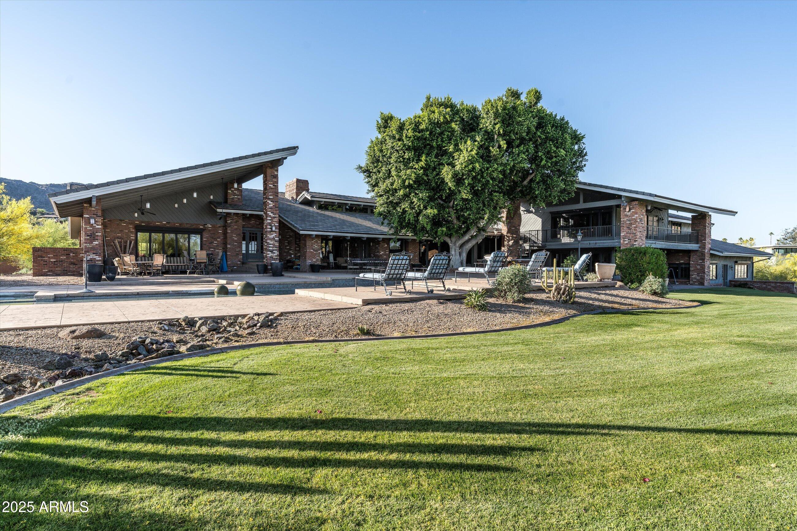6830 North 46th Place Paradise Valley, AZ 85253 - Photo 55 of 65 a swimming pool view with a seating space and a garden view