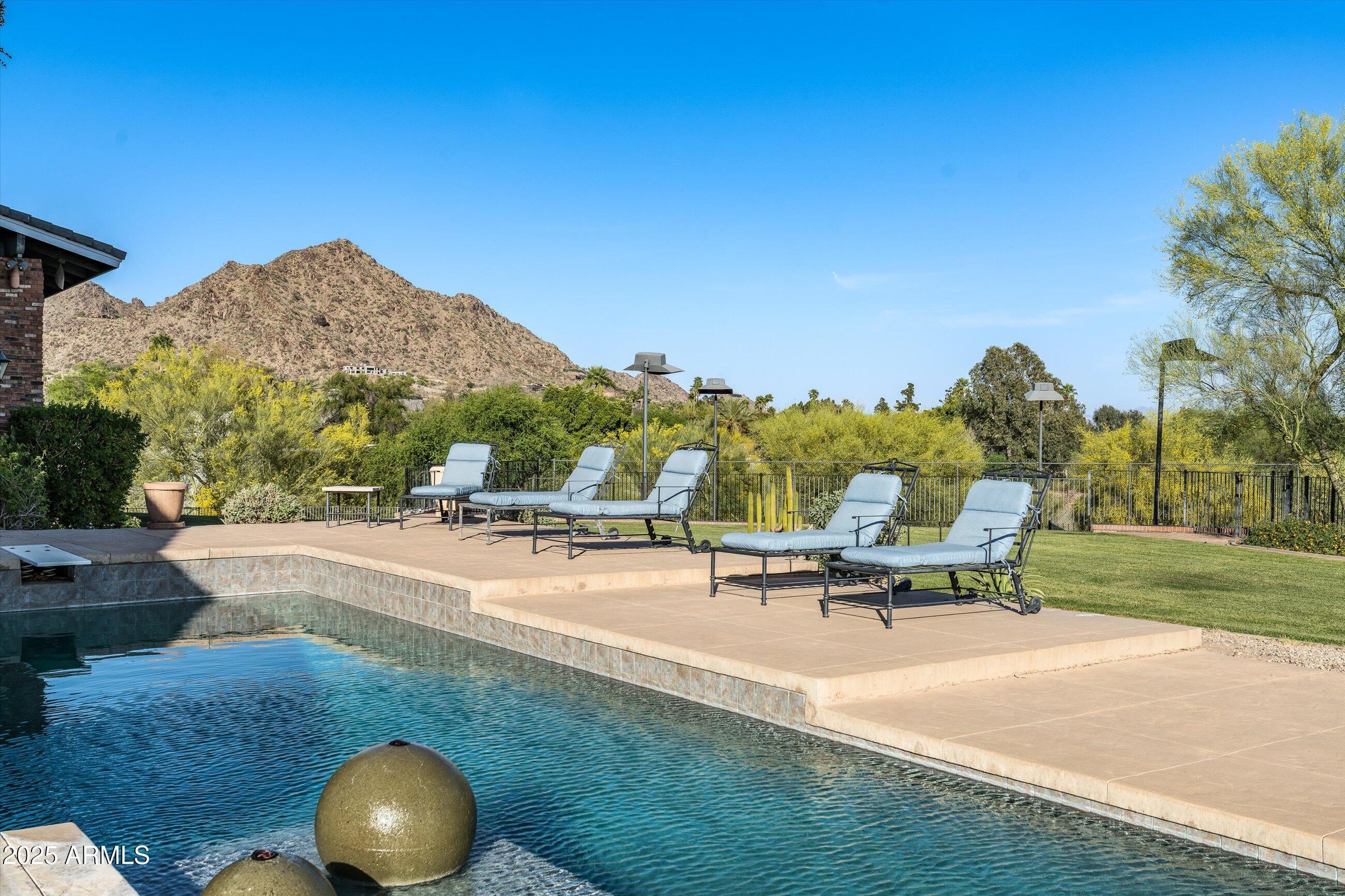 6830 North 46th Place Paradise Valley, AZ 85253 - Photo 58 of 65 a view of a swimming pool with a patio and garden