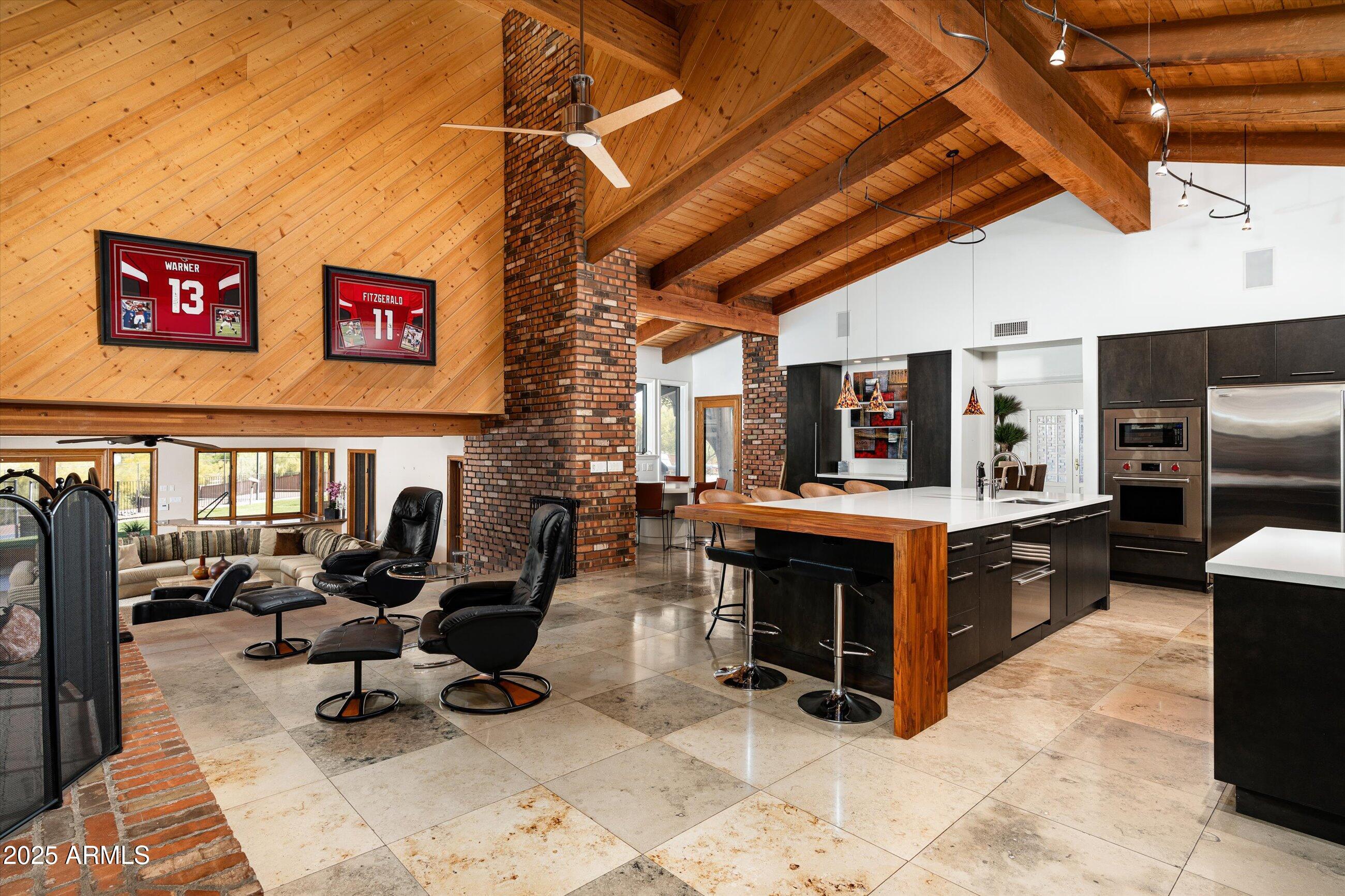 6830 North 46th Place Paradise Valley, AZ 85253 - Photo 8 of 65 a living room with furniture a flat screen tv and kitchen view