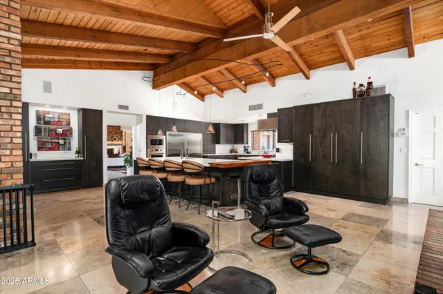 a living room with furniture and floor to ceiling windows