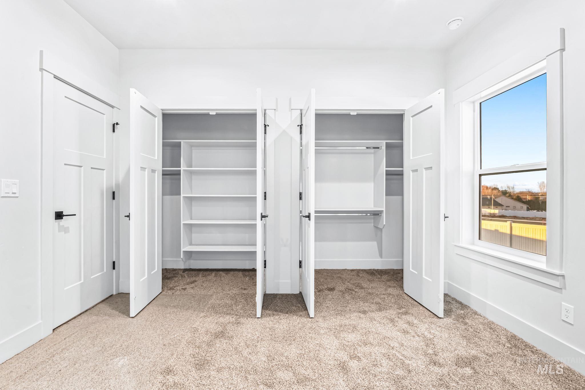 2905 Cypress Point Payette, ID 83661 - Photo 10 of 26 Unfurnished bedroom featuring two closets and light carpet