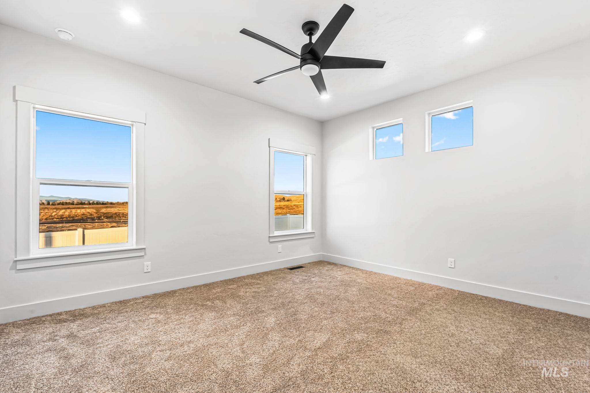 2905 Cypress Point Payette, ID 83661 - Photo 11 of 26 Unfurnished room with plenty of natural light, carpet, a ceiling fan, and recessed lighting