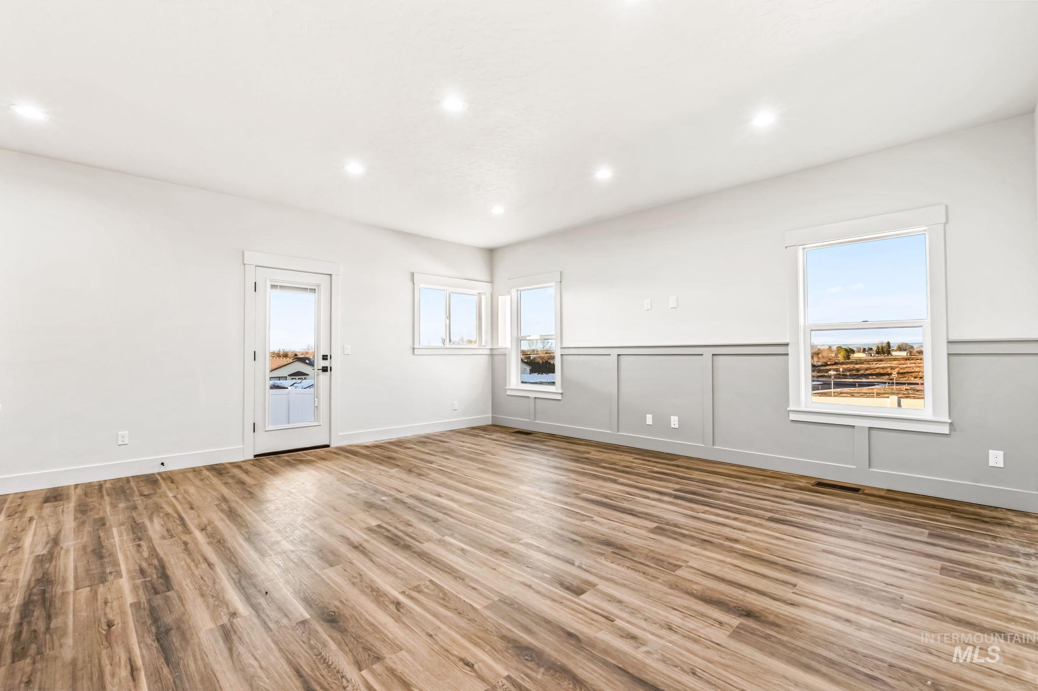 2905 Cypress Point Payette, ID 83661 - Photo 6 of 26 Unfurnished room with light wood-type flooring, recessed lighting, plenty of natural light, and a decorative wall