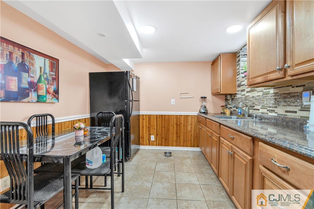 208 Oak Place Piscataway, NJ 08854 - Photo 12 of 23 a kitchen with stainless steel appliances granite countertop a sink and a refrigerator