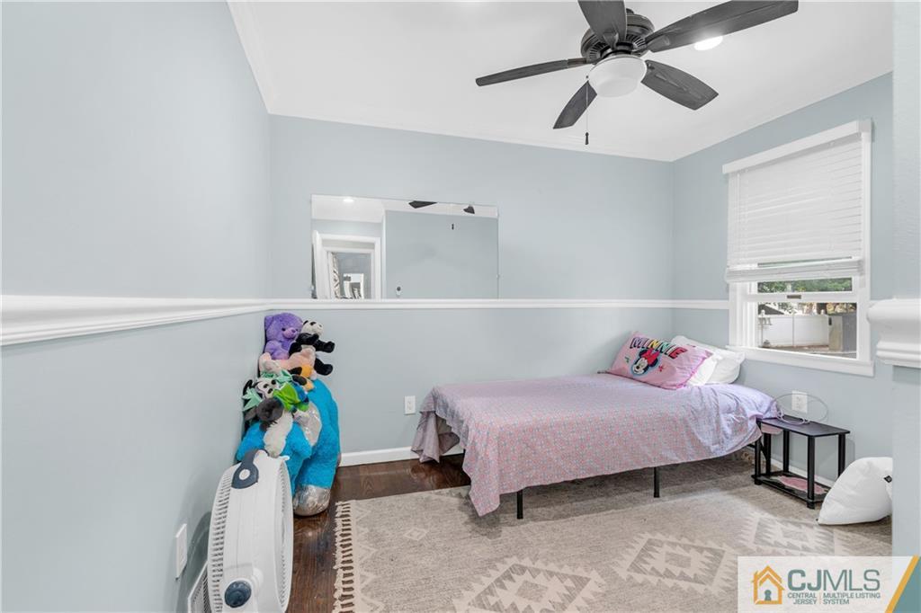 208 Oak Place Piscataway, NJ 08854 - Photo 8 of 23 a bedroom with a bed and a chandelier