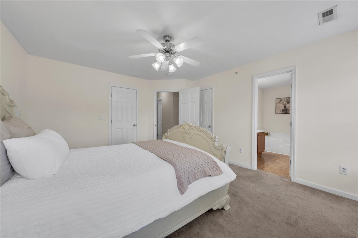 4015 Clinton Lane Spring Hill, TN 37174 - Photo 11 of 40 a bedroom with a large bed and a chandelier