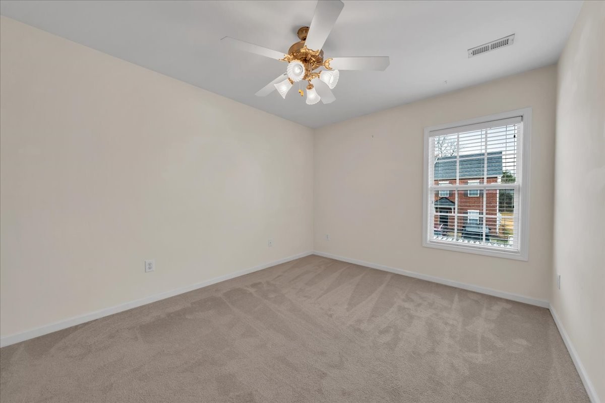 4015 Clinton Lane Spring Hill, TN 37174 - Photo 15 of 40 an empty room with a chandelier fan and windows