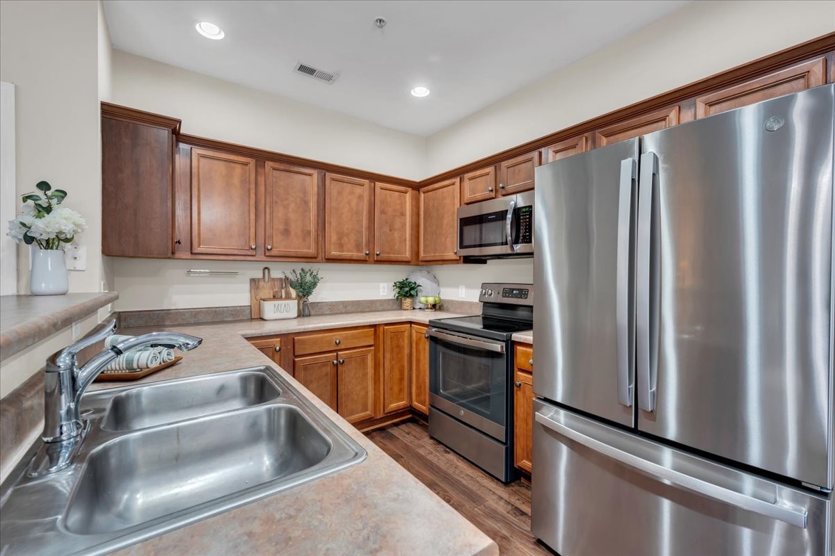 4015 Clinton Lane Spring Hill, TN 37174 - Photo 6 of 40 a kitchen with stainless steel appliances granite countertop a refrigerator sink and stove