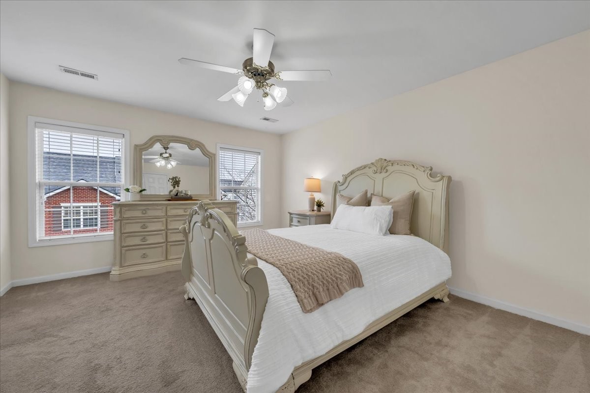 4015 Clinton Lane Spring Hill, TN 37174 - Photo 10 of 40 a spacious bedroom with a bed a chandelier and dresser
