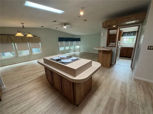 a kitchen with stainless steel appliances granite countertop a stove and a wooden floors